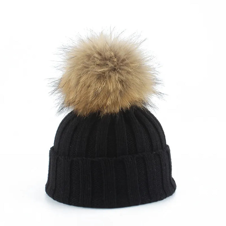 Women's cozy winter pom-pom beanie hat, soft knit for warmth & style in cold weather.