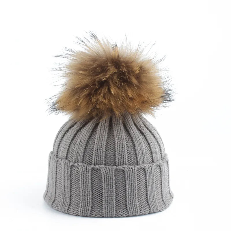 Soft knit women's beanie with a stylish pom-pom. Perfect cozy headwear for cold winter days.