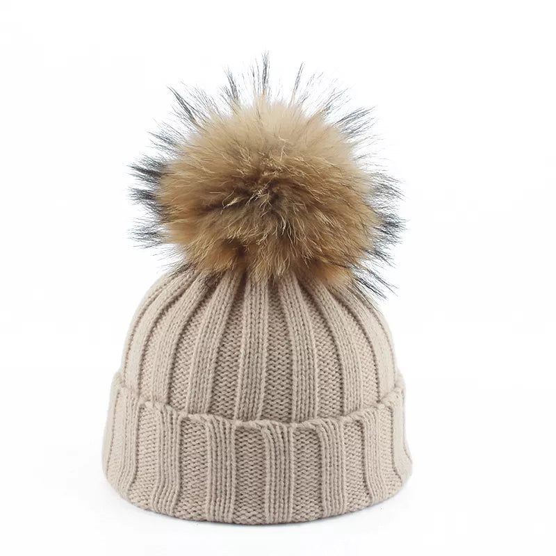 Stylish women's winter pom-pom beanie. Cozy and warm fashion accessory for cold weather outfits.