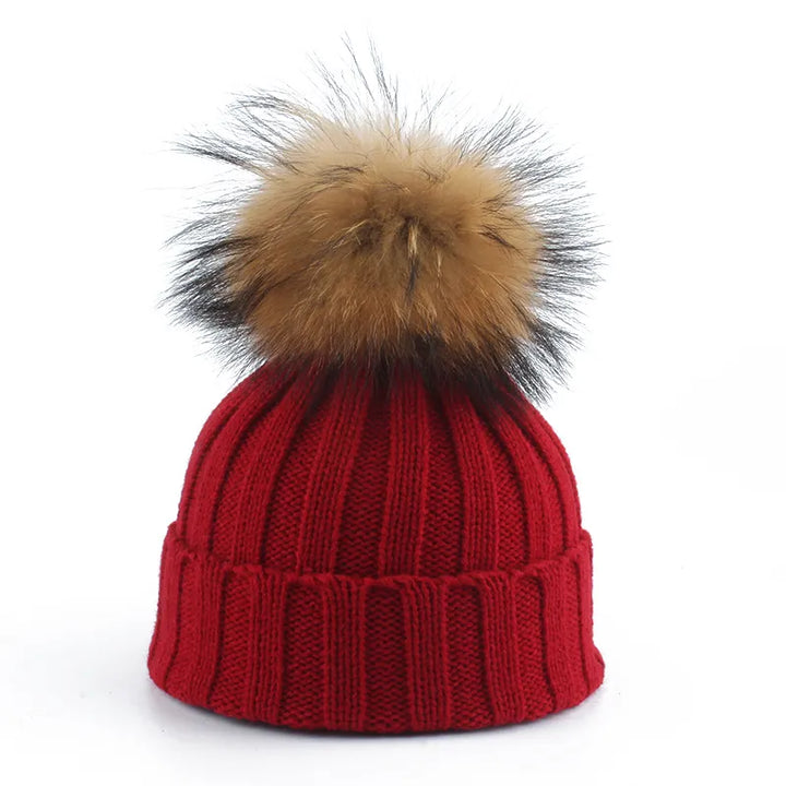Women's warm and cozy winter beanie hat with a fluffy pom-pom, great for cold weather fashion.