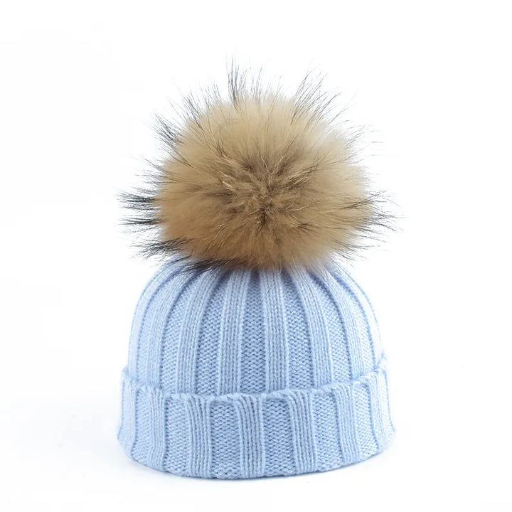 Fashionable women's pom-pom beanie, designed for warmth & comfort in winter. A cozy headwear essential.