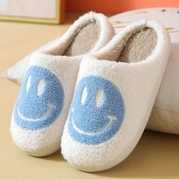 Side view of women's cozy winter smiley slippers, showing the thick sole & soft, warm plush material.