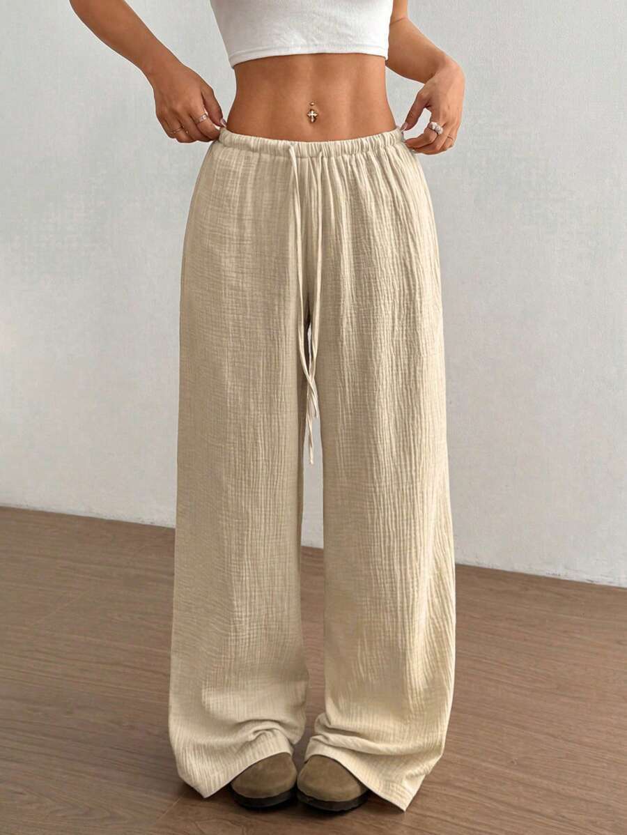 Stylish women's crinkle wide-leg drawstring pants, offering an effortless, comfortable look for summer.