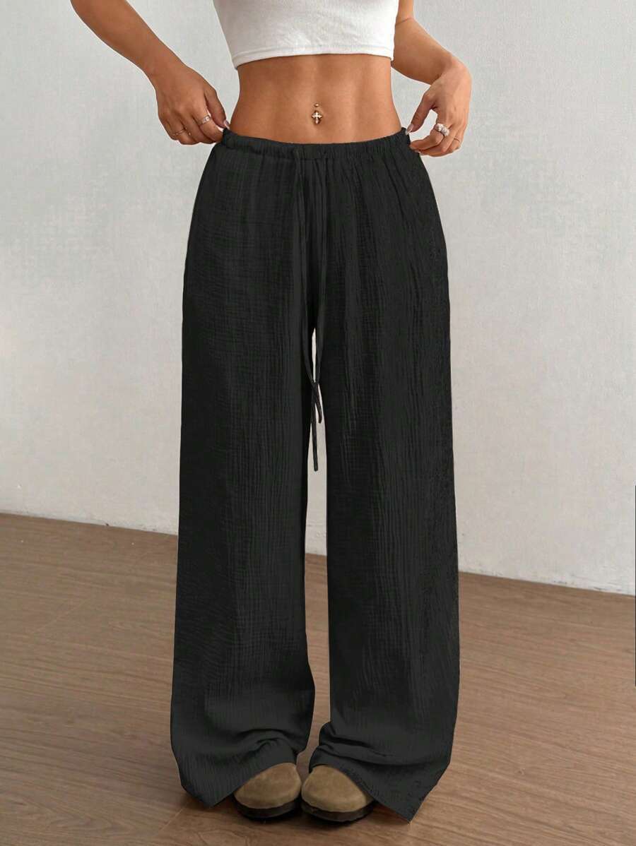 Bohemian style women's crinkle wide-leg drawstring pants, offering a relaxed and effortless summer look.