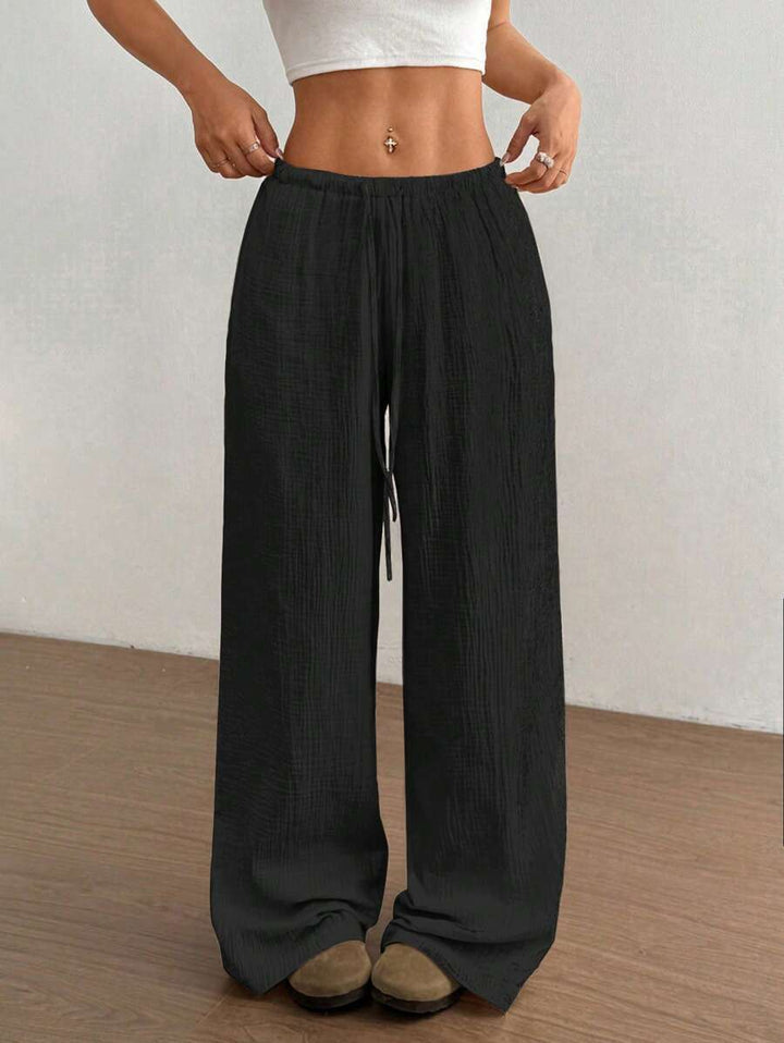 Bohemian style women's crinkle wide-leg drawstring pants, offering a relaxed and effortless summer look.