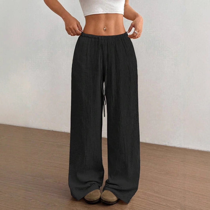 Crinkle textured women's wide-leg drawstring pants, a comfortable relaxed fit for summer fashion.
