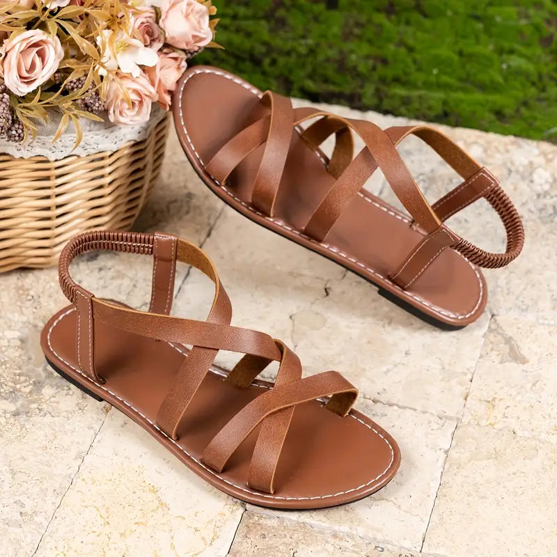 Women's comfortable flat criss-cross Roman sandals for summer. Slip-on casual footwear.