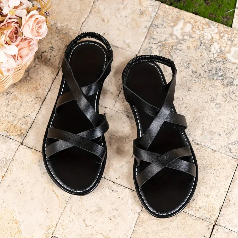 Versatile women's flat Roman sandals with criss-cross design, great for casual summer outfits.