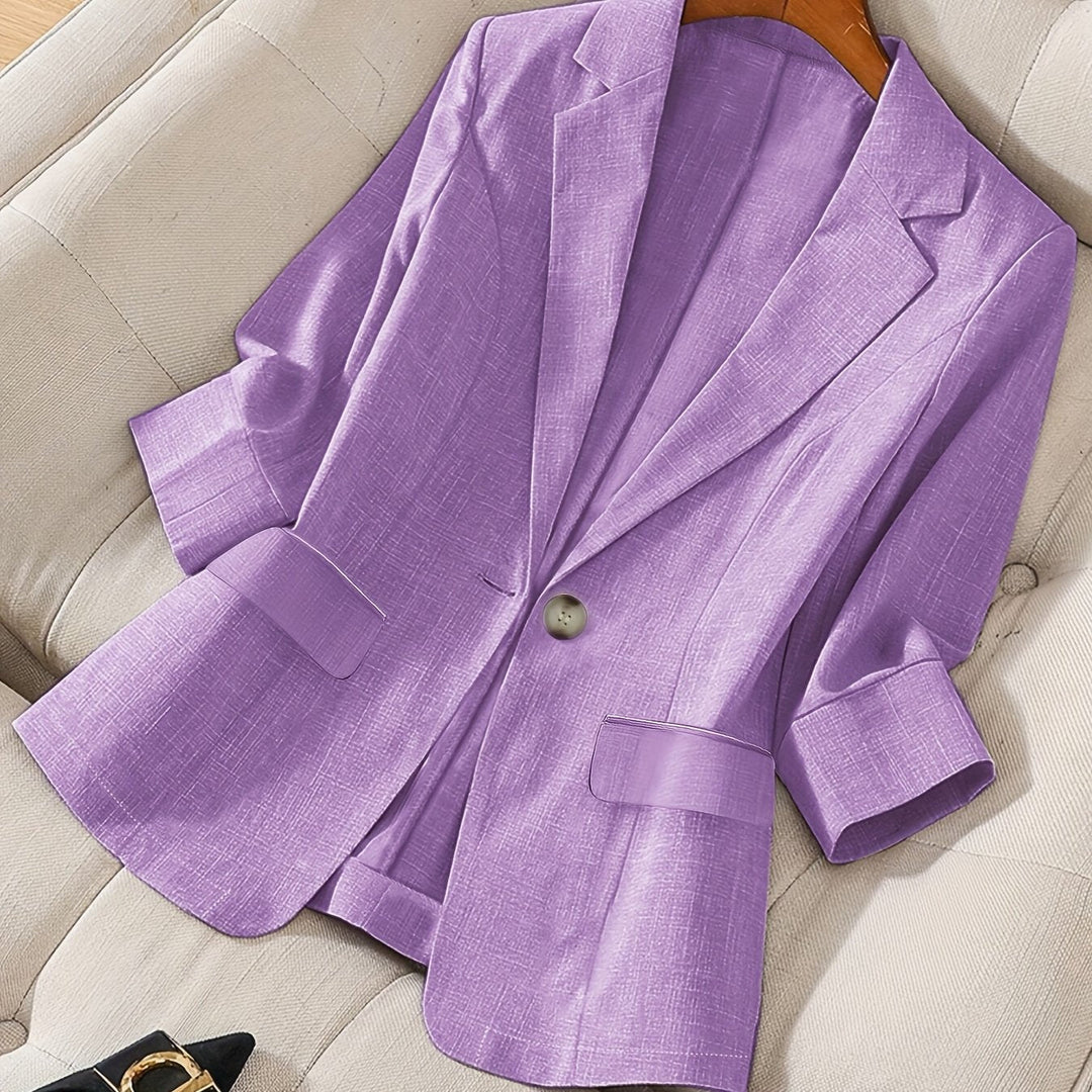 Modern women's cropped blazer with a chic three-quarter sleeve design.