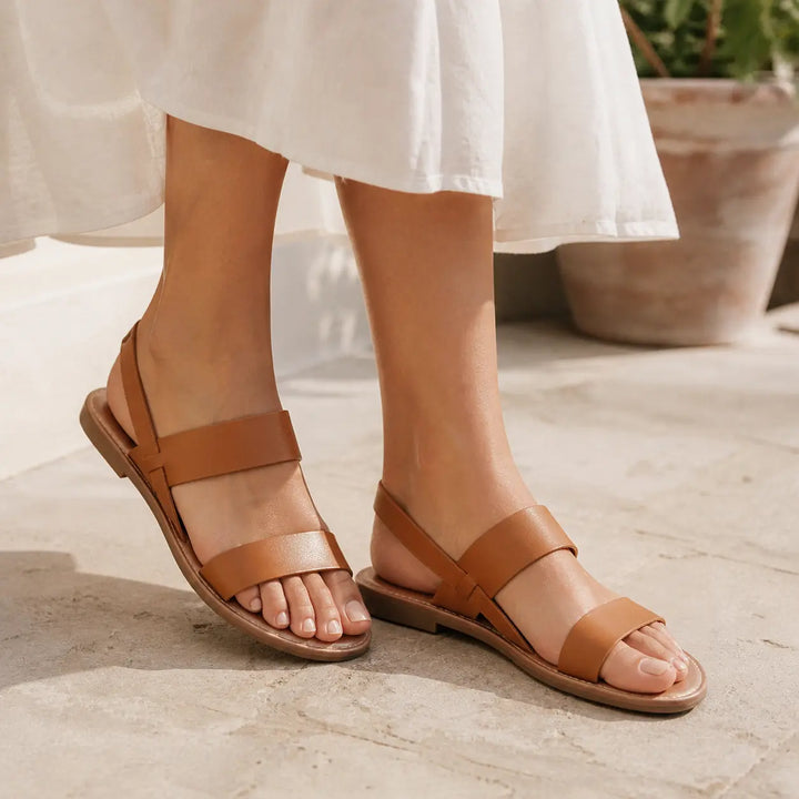 Comfortable women's open-toe flat sandals with chic crossover straps for casual style.