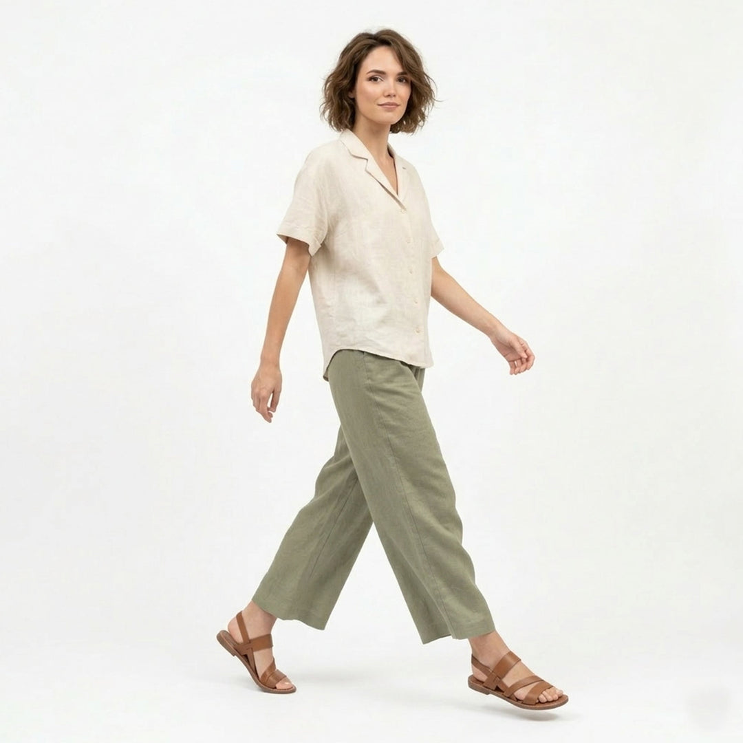 Close-up of women's flat sandals with elegant crossover strap detail and open toe design.