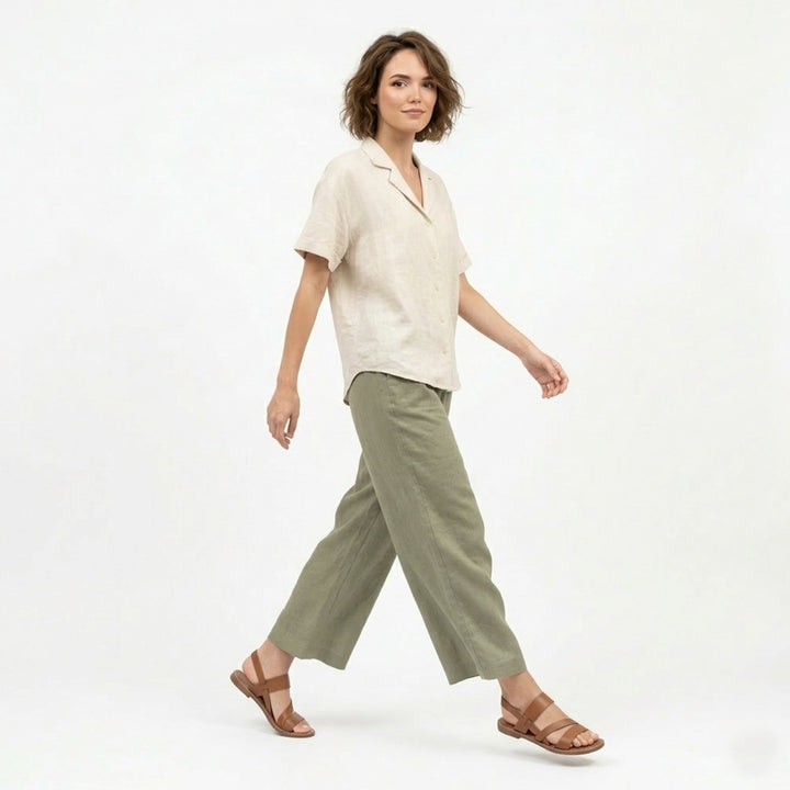 Close-up of women's flat sandals with elegant crossover strap detail and open toe design.