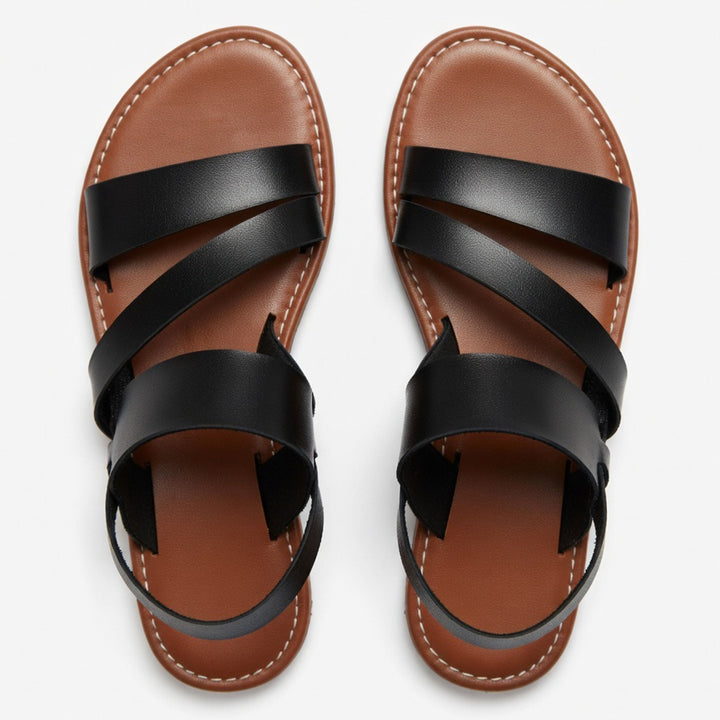 Women's flat sandals with crossover strap and open toe, great for comfortable summer walks.