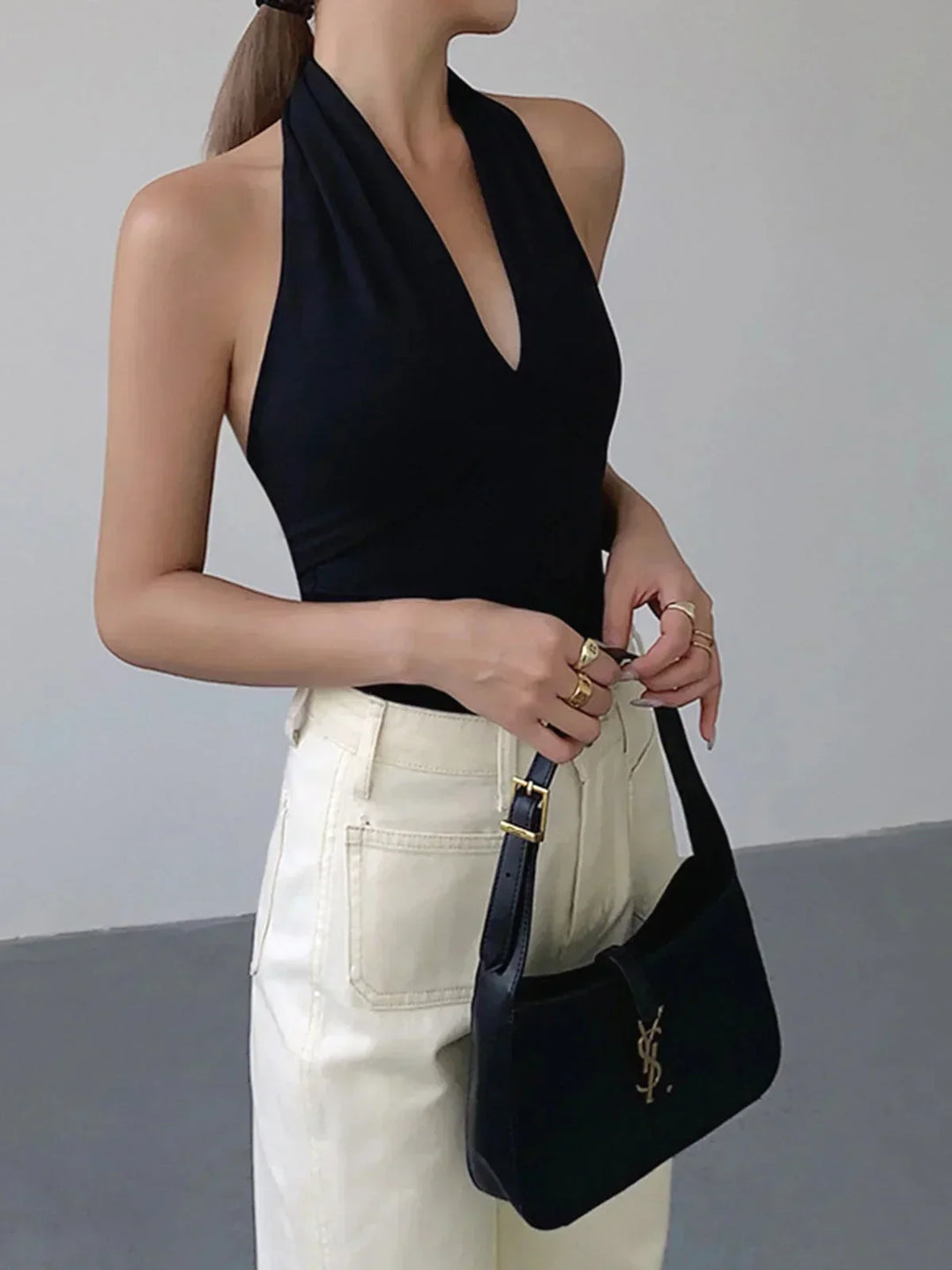 Slim fit women's halter top with V-neck, perfect for versatile casual wear. Chic sleeveless summer style.