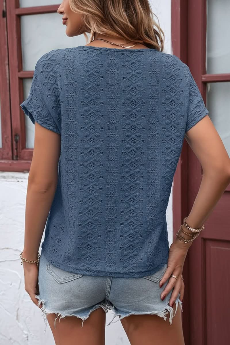 Relaxed fit women's short sleeve t-shirt featuring intricate eyelet embroidery and a notched collar.