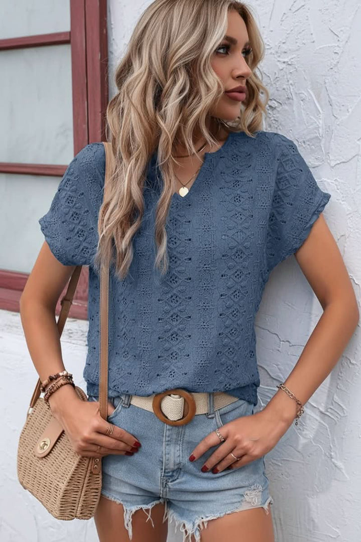 Embroidered eyelet women's top, white, with a chic notched neckline, ideal for warm weather casual wear.