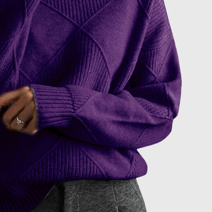 Comfortable women's knit sweater with roll neck and unique diagonal seam detail.