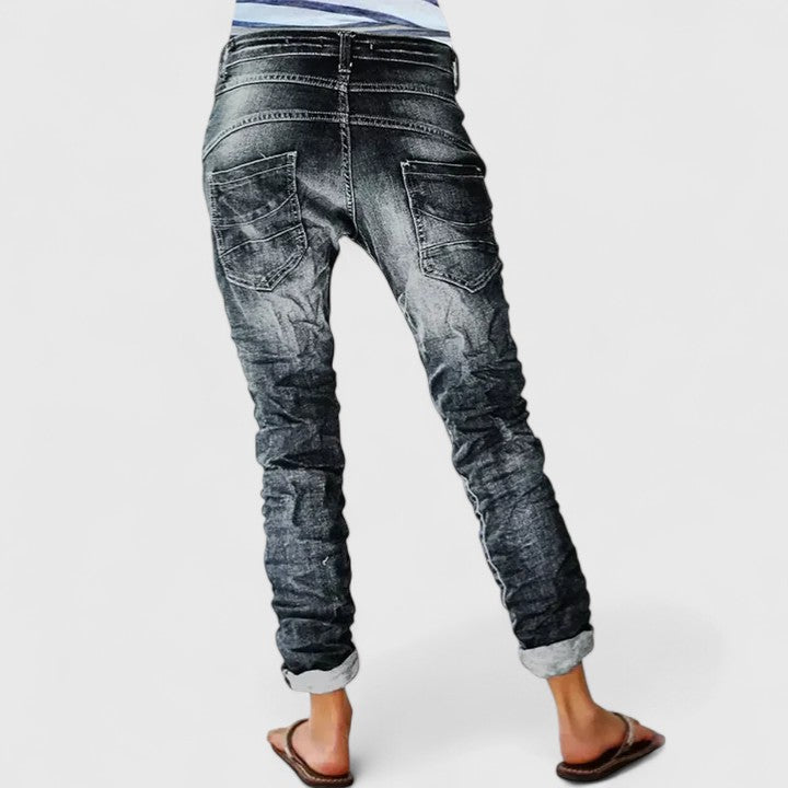 Women's distressed wide leg jeans, relaxed fit, mid-rise denim for casual style.