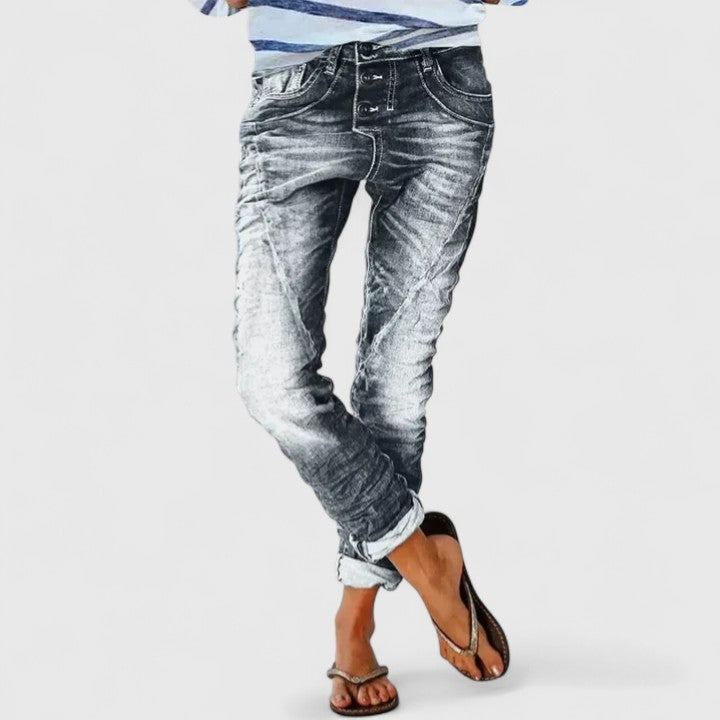 Women's mid-rise distressed wide leg jeans in blue, relaxed fit, casual trendy fashion.