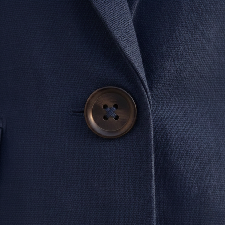Elegant two-piece women's outfit: double-breasted blazer with notched lapel & coordinating high-waist shorts.