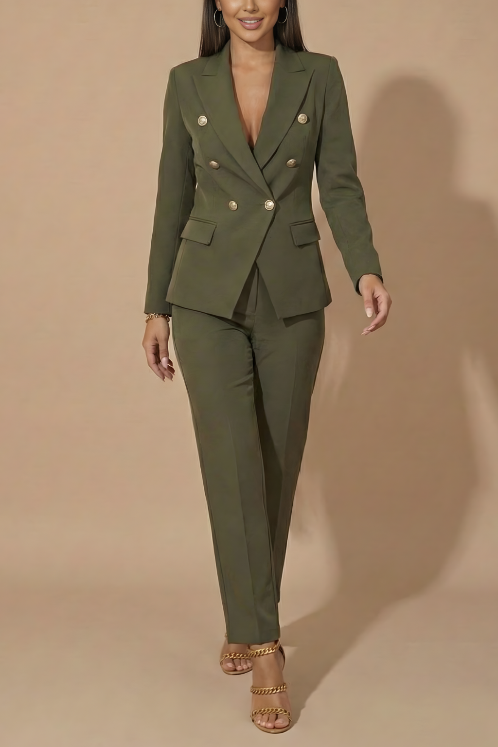 Close-up: Gold buttons on a women's elegant double-breasted blazer, part of a tailored formal trouser suit.