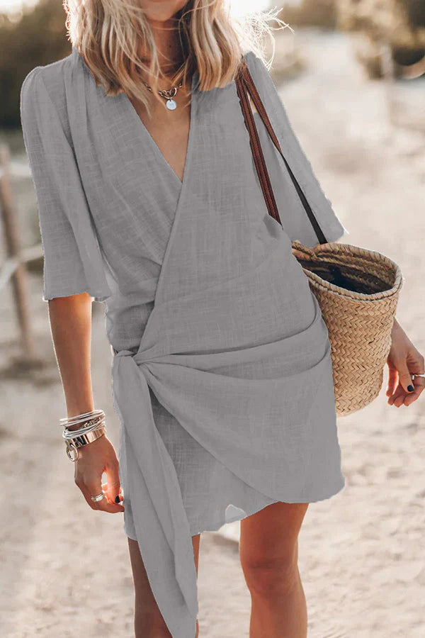 Women's Draped V-Neck Mini Dress in a vibrant color, perfect for summer days or vacation wear.