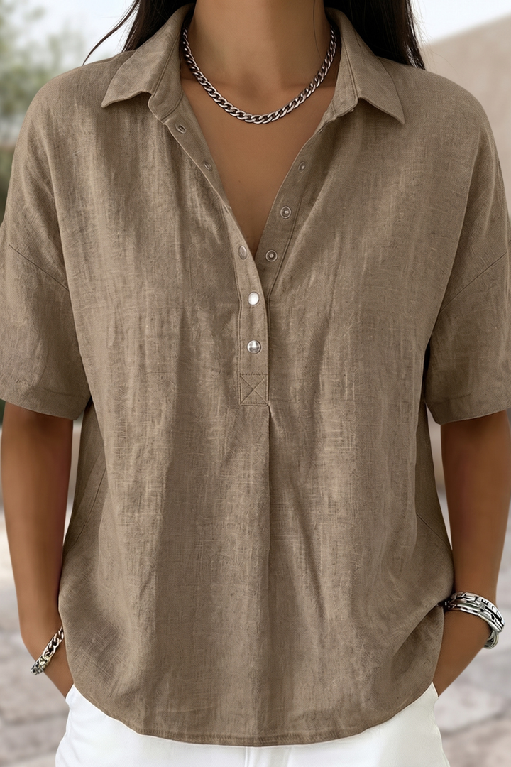 Women's effortless button-up blouse, long-sleeve, ideal for office wear or sophisticated casual style.