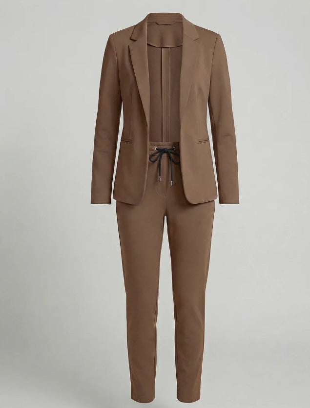 Fashionable women's two-piece suit. Effortless chic blazer & matching pants set for a sophisticated modern outfit.