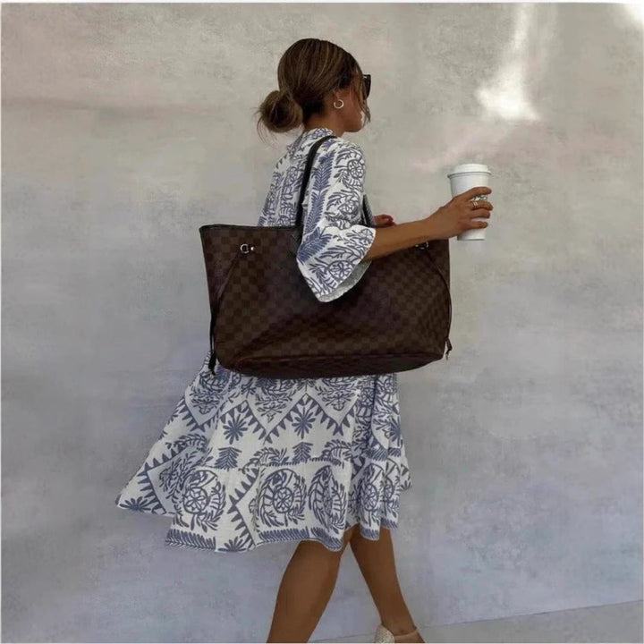Printed floral sundress for women, showcasing a tiered skirt, elbow sleeves, & boho casual style.