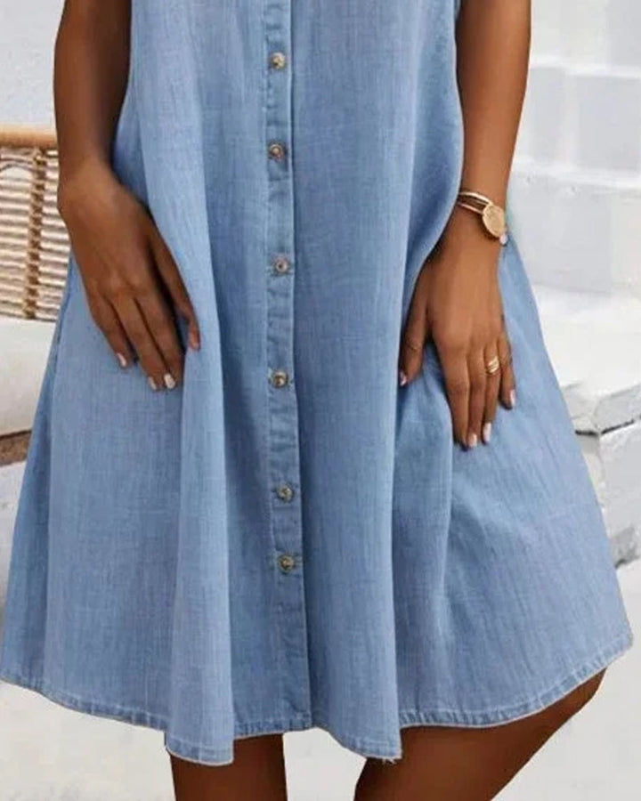 Spring/Summer women's lightweight denim-look dress. Features a classic button-down front for effortless style.