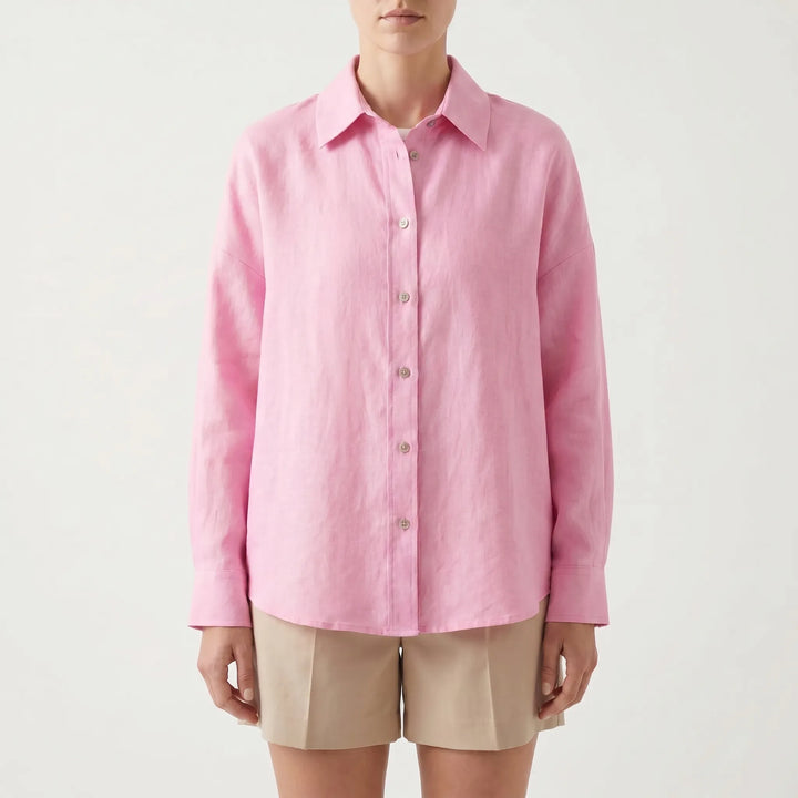 Back view of a women's oversized button-down shirt, long sleeve, showing relaxed fit and effortless design.