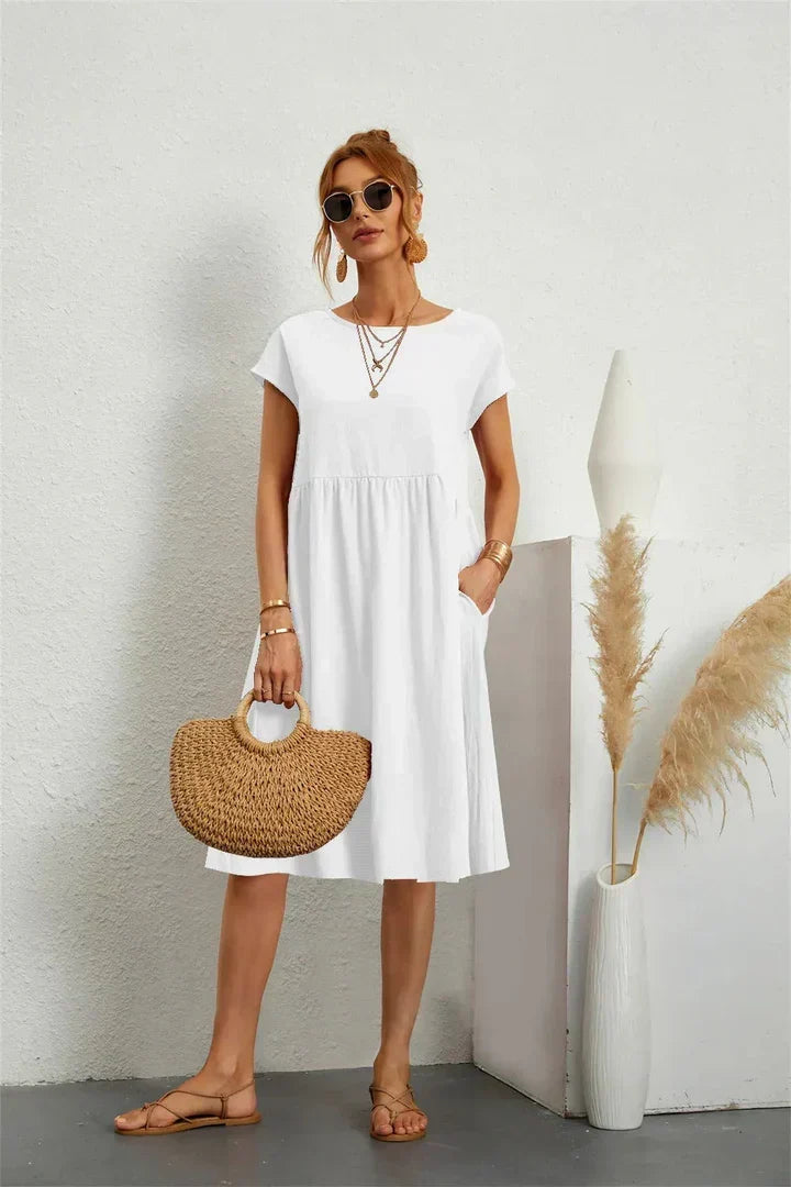 Effortless chic midi dress for women, featuring a comfortable relaxed fit and convenient pockets.