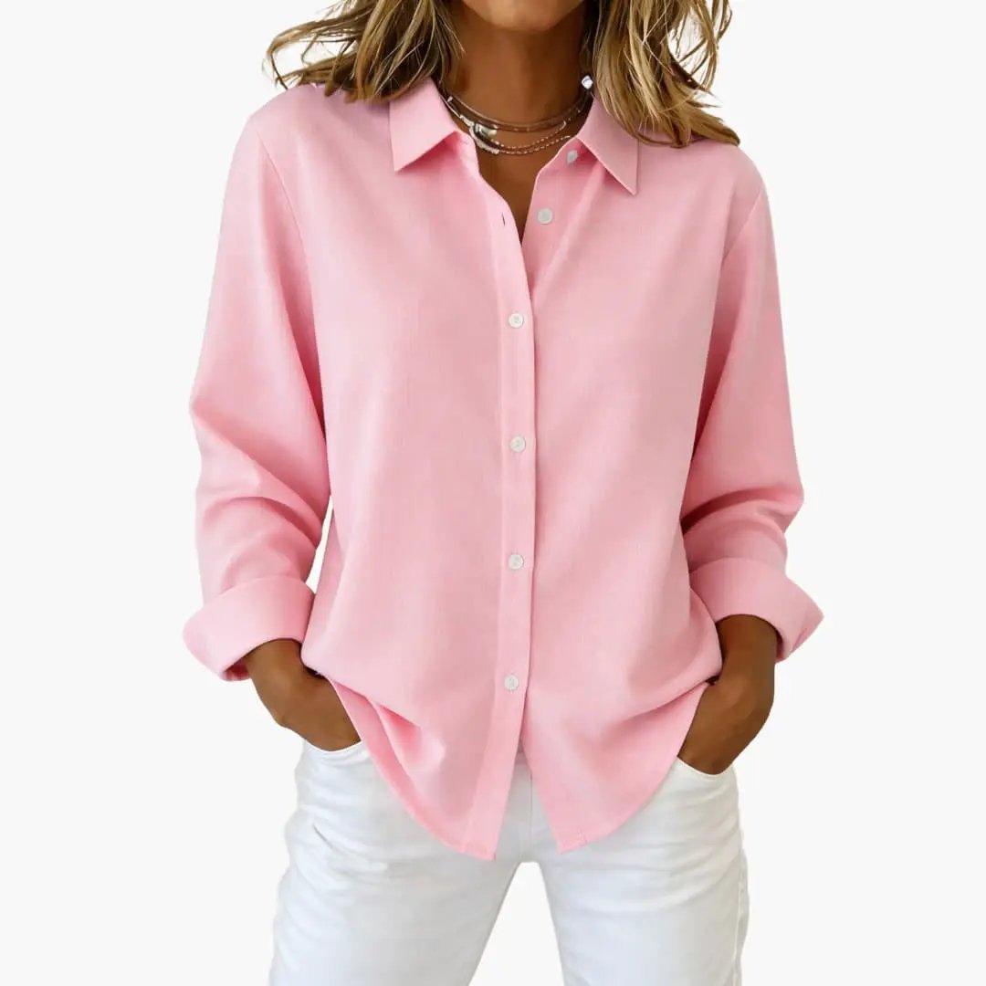 Detail shot of buttons on a women's relaxed fit button-up shirt; elegant and practical design.