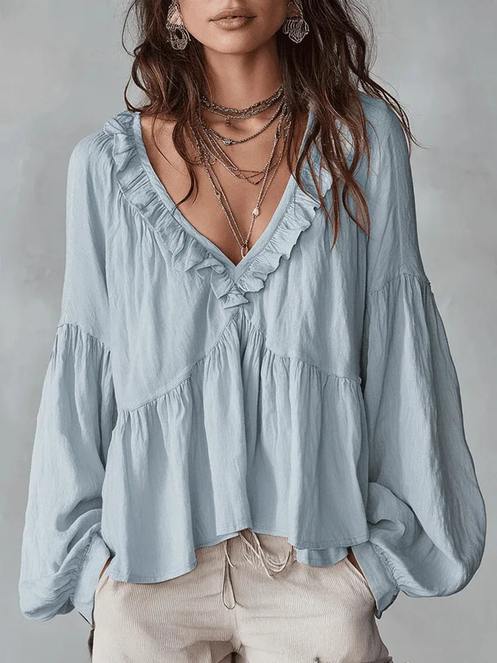 Elegant women's ruffle blouse, perfect for stylish everyday wear. Lightweight, loose-fit fashion top for comfort.