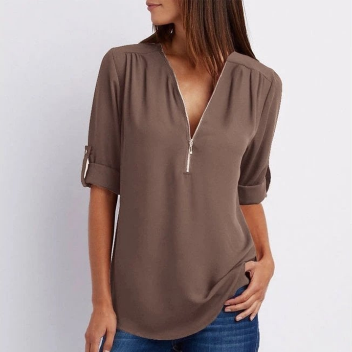 Relaxed fit women's V-neck blouse with convertible roll-up sleeves, ideal for comfortable daily style.