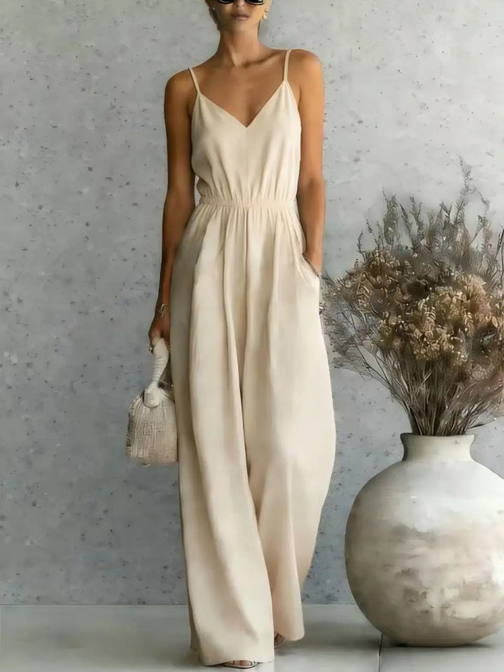 Stylish V-neck wide-leg jumpsuit for women. Sleeveless, one-piece, ideal for relaxed summer days & vacations.