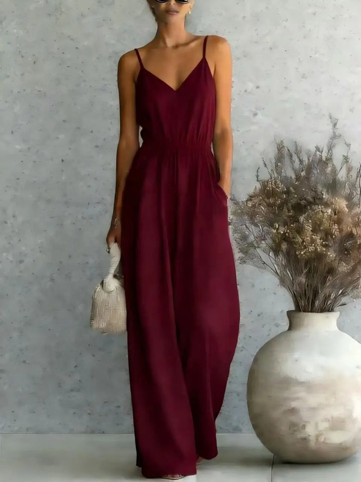 Relaxed fit women's wide-leg jumpsuit. V-neck, comfortable and effortless style for casual summer and vacation wear.