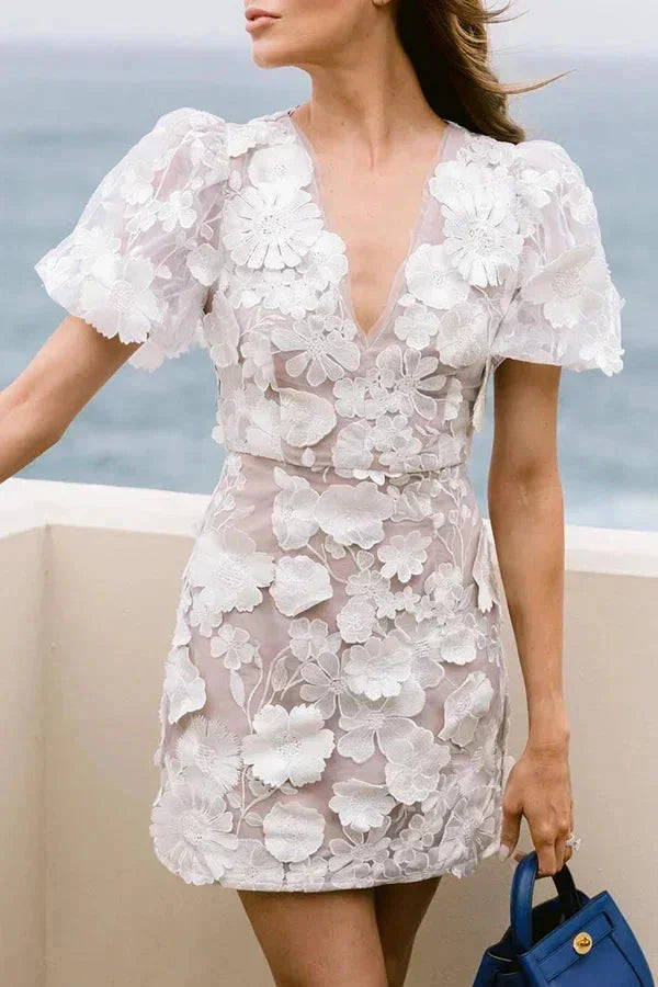 Elegant women's summer mini dress with delicate 3D floral appliqué, stylish puff sleeves, and a V-neck.