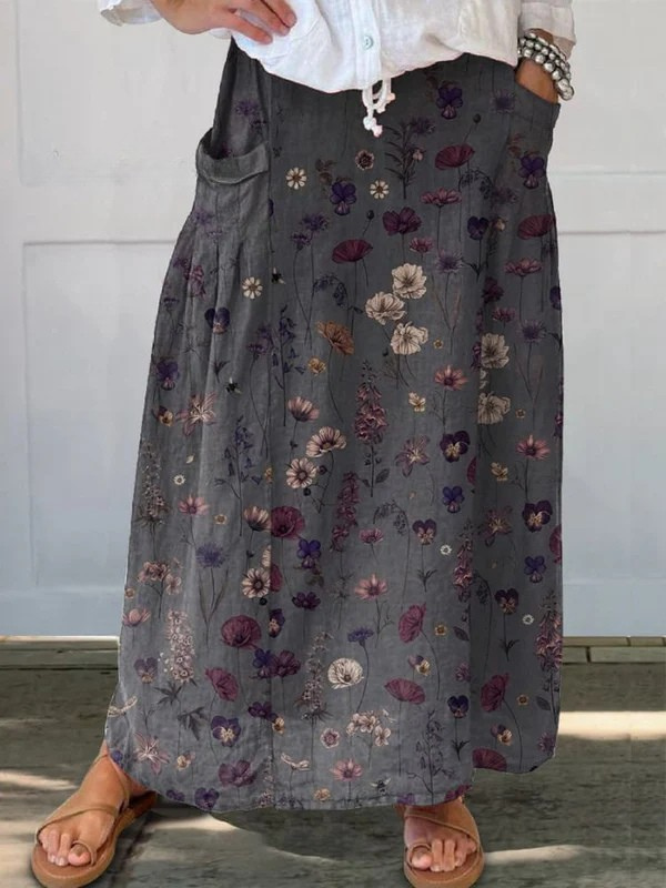 Women's elegant A-line midi skirt with artistic flower print. Features convenient pockets, perfect for spring/summer casual wear.