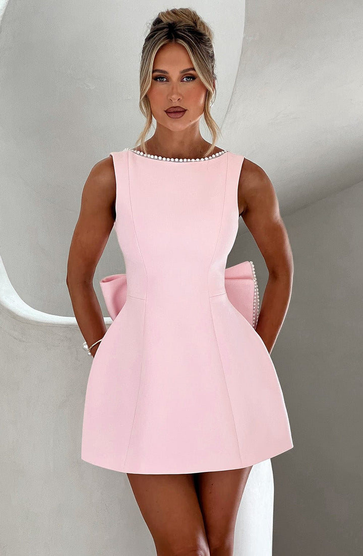 Women's elegant A-line mini homecoming dress with delicate pearl trim and bow detail. Perfect for special occasions.