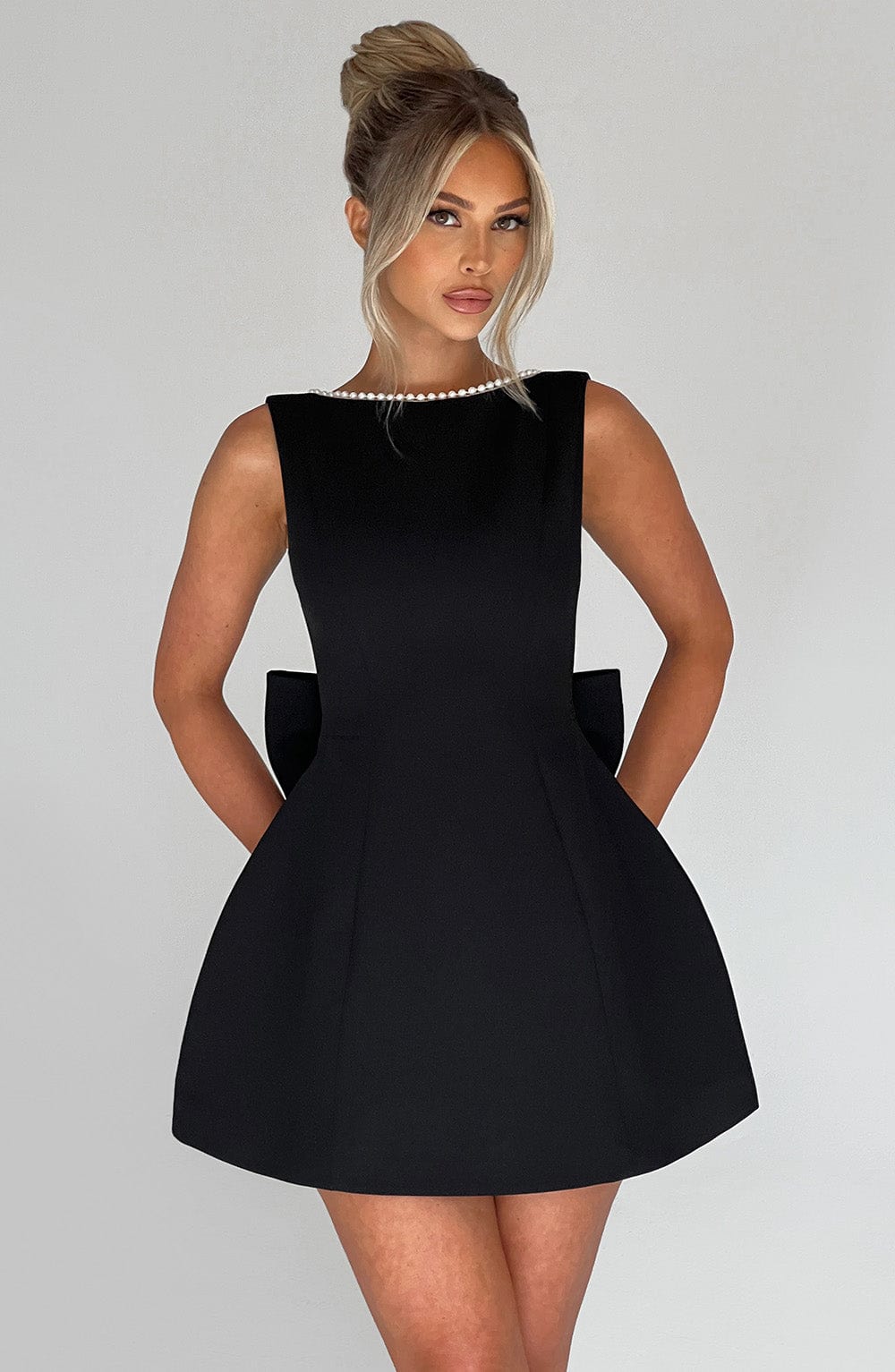 Elegant pearl-embellished A-line mini homecoming dress for women with a stylish bow detail. Special occasion wear.