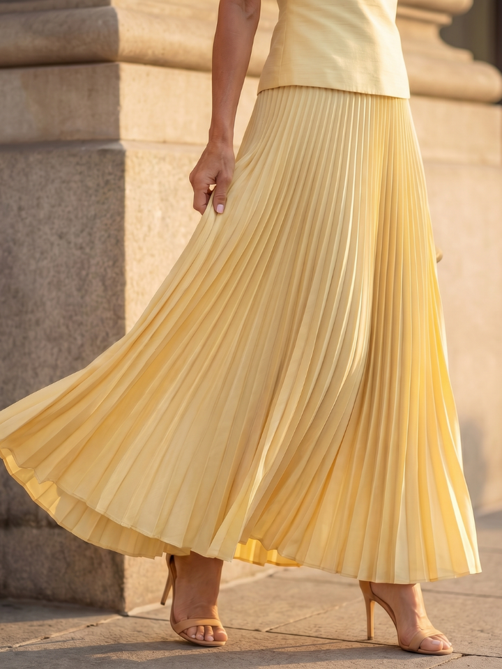 Pink two-piece women's outfit: structured sleeveless top & elegant pleated maxi skirt, day to night.