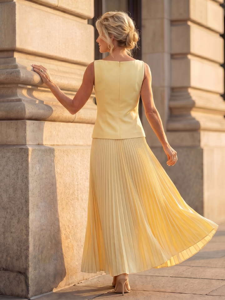 Sky blue women's fashion skirt set, featuring a structured bodice & a chic pleated maxi skirt.