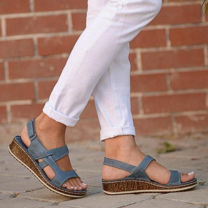 Chic women's wedge sandals, ideal for summer outfits. Comfortable elevated platform footwear.