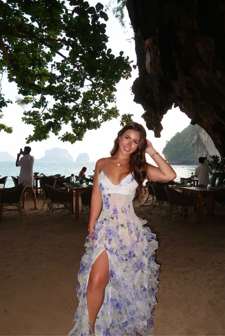 Stunning women's blue floral maxi dress. Features a trendy corset bodice and graceful ruffled skirt for occasions.