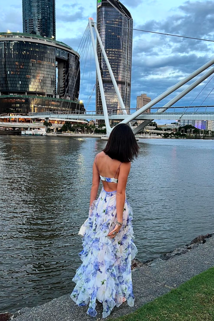 Women's blue floral corset ruffle maxi dress. Elegant wedding guest, party, or summer occasion outfit.
