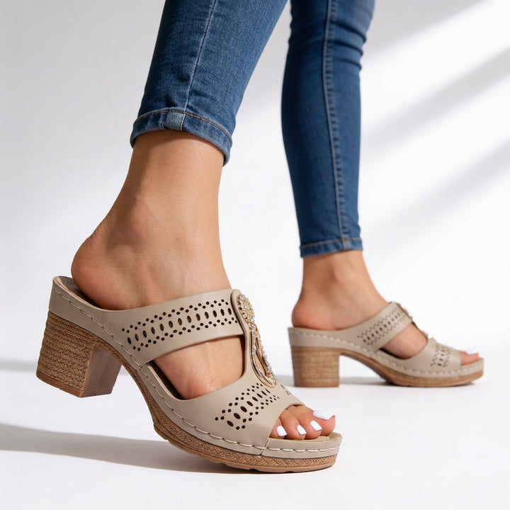 Slip-on open-toe women's sandals featuring a sturdy block heel and glittering rhinestone T-strap.