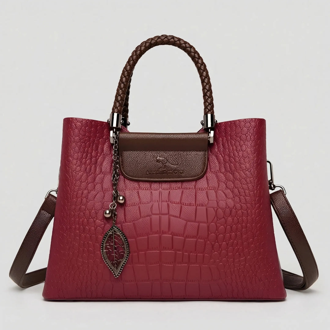 Red women's embossed handbag with a distinctive braided handle. A stylish and versatile shoulder tote for any occasion.