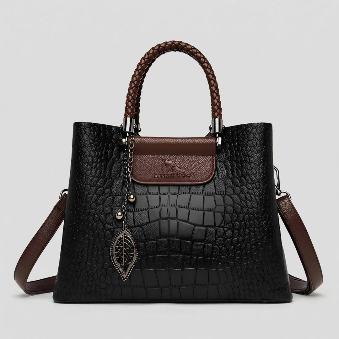 Black embossed tote bag for women. This stylish handbag features a unique braided handle & spacious design.