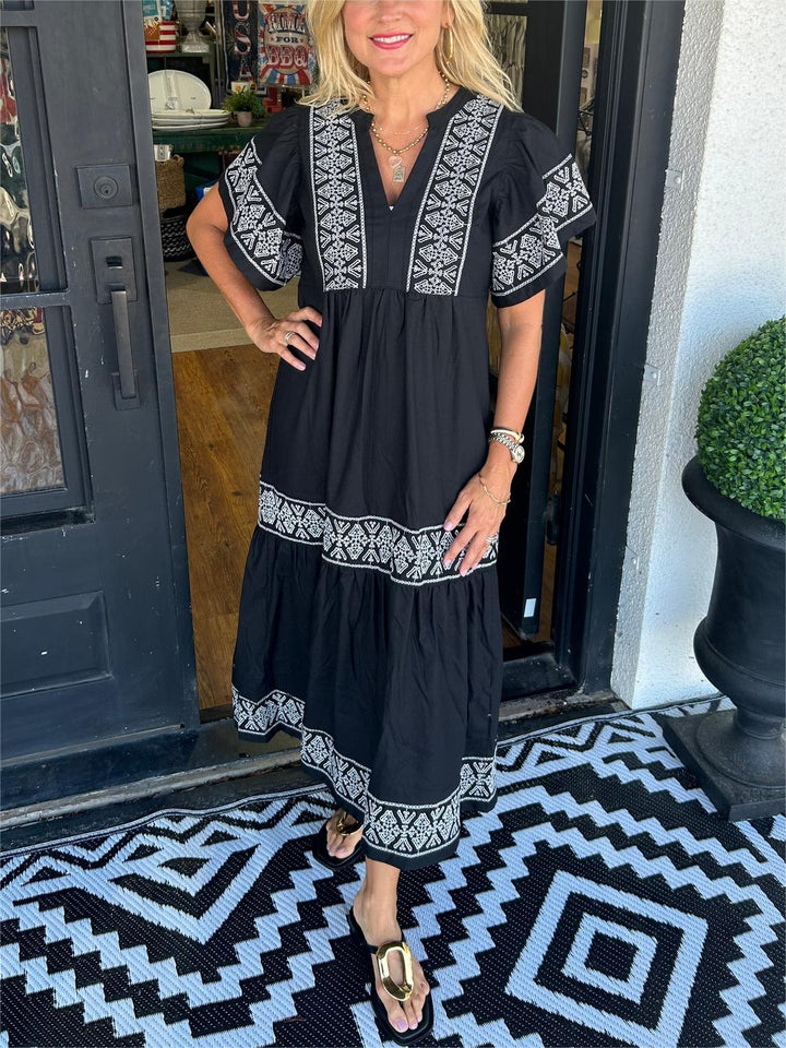 Boho midi dress for women, featuring intricate embroidery and an elegant silhouette, ideal for summer fashion.